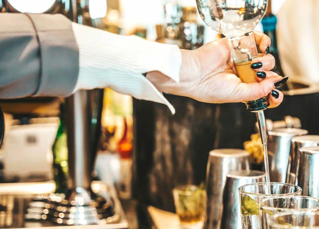 A drink being poured at the bar
